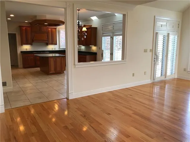 a view of a hallway with wooden floor and a cabinet