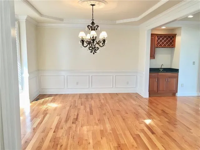 a view of kitchen and hall with wooden floor