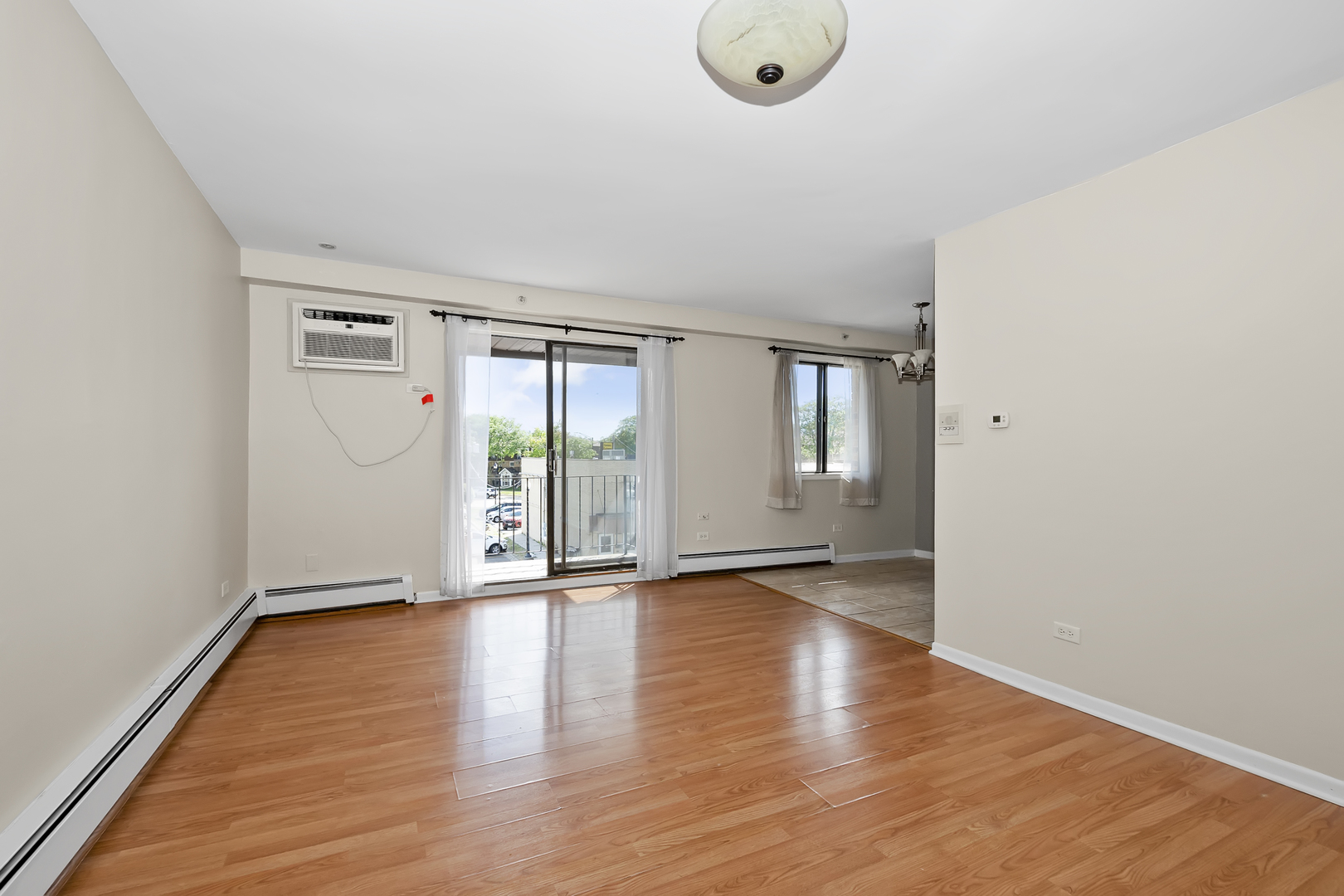 6348 Washington Street, Unit 3A Chicago Ridge, IL 60415 - Photo 3 of 17 an empty room with wooden floor and windows