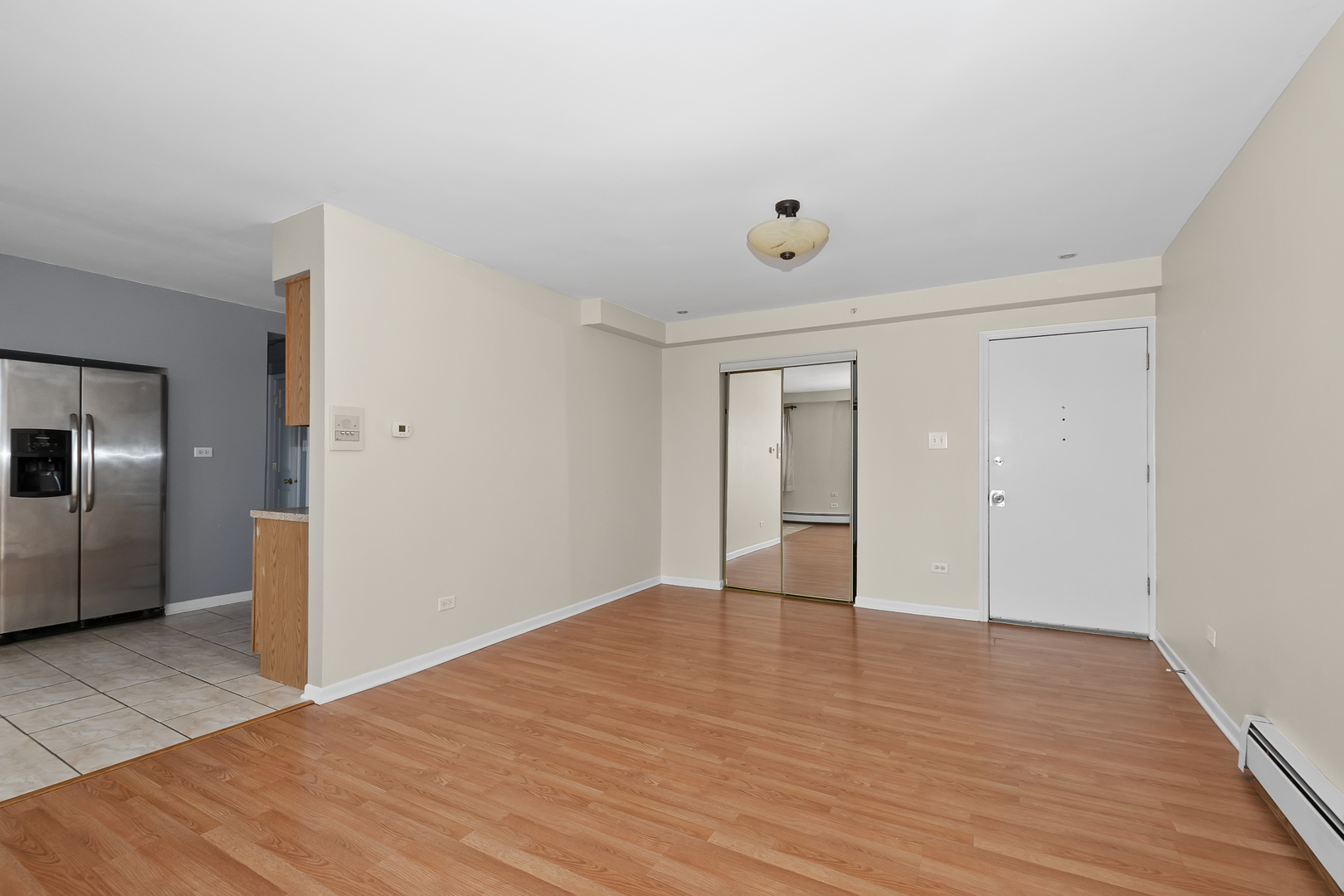 6348 Washington Street, Unit 3A Chicago Ridge, IL 60415 - Photo 4 of 17 a view of an empty room with wooden floor and closet