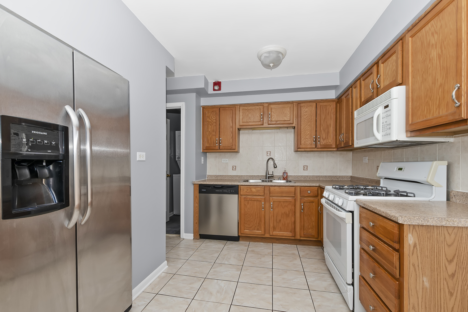 6348 Washington Street, Unit 3A Chicago Ridge, IL 60415 - Photo 6 of 17 a kitchen with stainless steel appliances granite countertop a refrigerator and a stove top oven