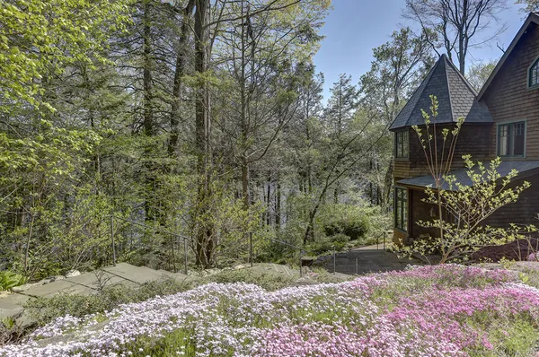 a pathway of a house with a yard