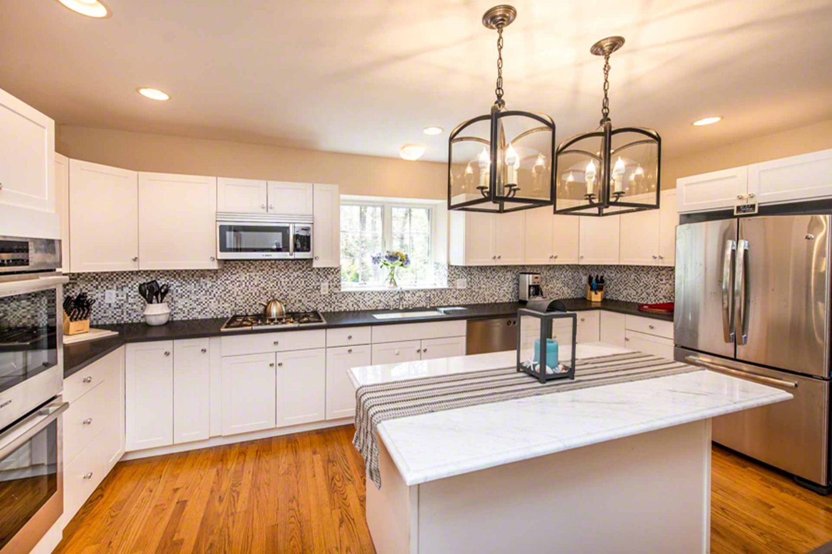 40 Dark Woods Road Edgartown, MA 02539 - Photo 13 of 20 a kitchen with stainless steel appliances granite countertop a sink a stove and a wooden floors