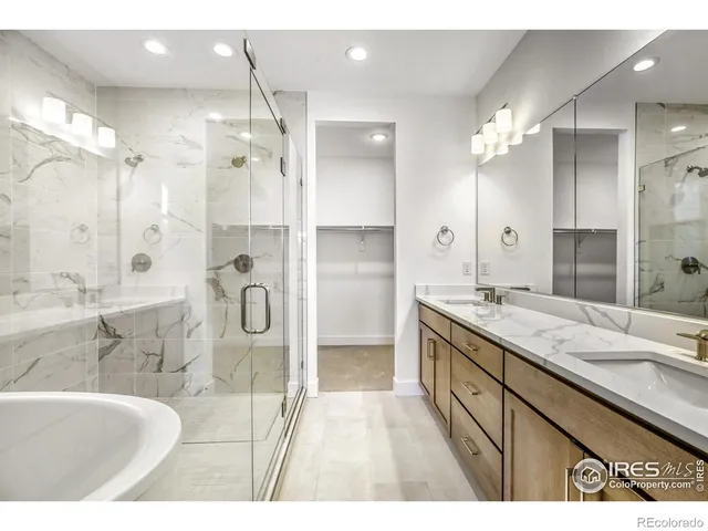 a bathroom with a granite countertop sink mirror and a shower