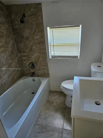 a bathroom with a sink a toilet and bathtub