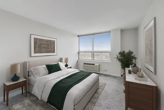 a bedroom with a large bed and a potted plant