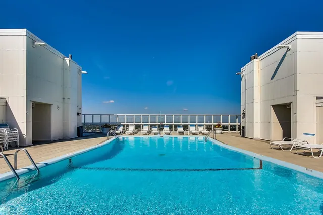 a view of a swimming pool with an outdoor seating and house