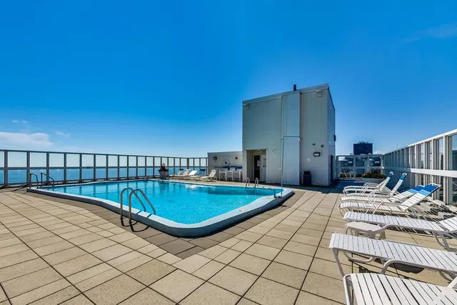 a view of swimming pool with outdoor seating