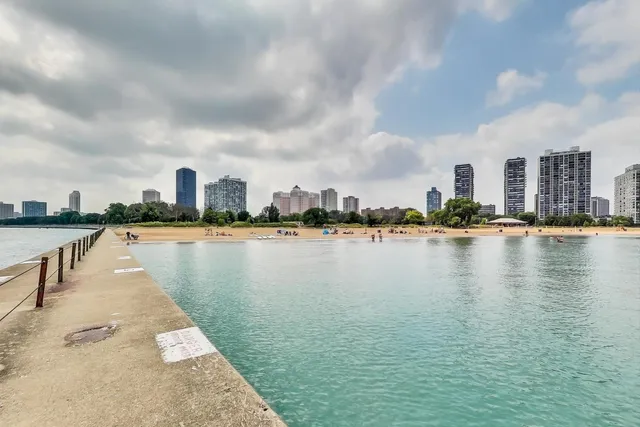 a view of a lake with boats and trees in the background