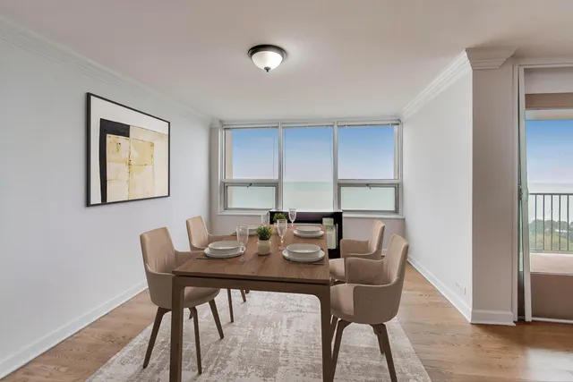 a view of a dining room with furniture and wooden floor