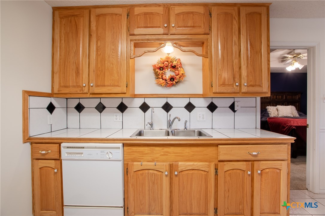 204 Grouse Road Victoria, TX 77905 - Photo 12 of 25 a bathroom with a sink and a white cabinets