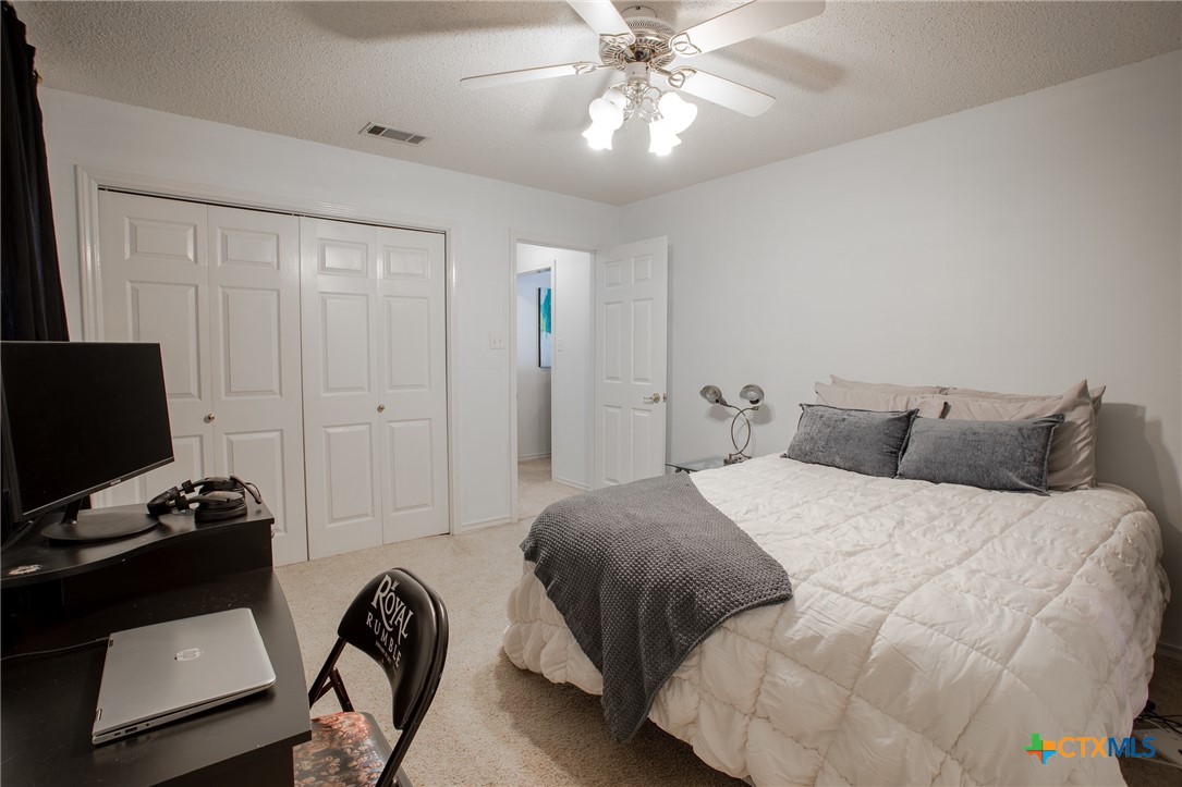 204 Grouse Road Victoria, TX 77905 - Photo 15 of 25 a bedroom with a bed and a flat tv screen on the dresser