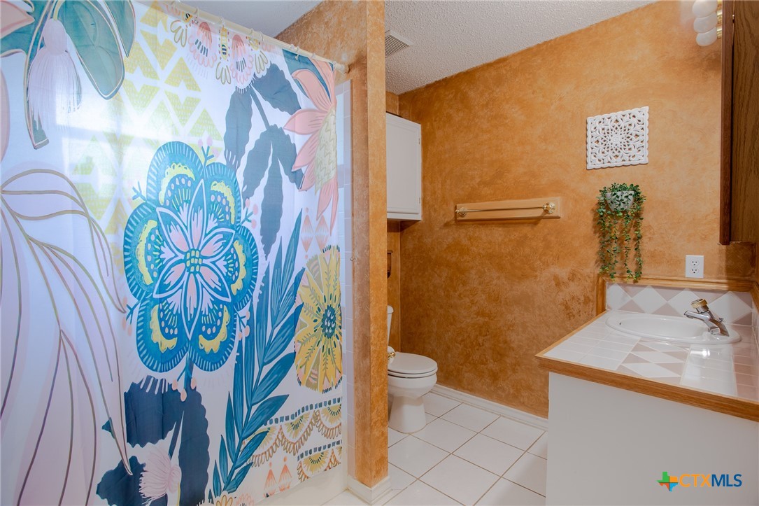 204 Grouse Road Victoria, TX 77905 - Photo 18 of 25 a bathroom with a sink and mirror with toilet