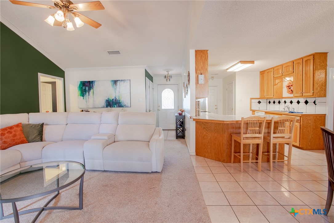 204 Grouse Road Victoria, TX 77905 - Photo 8 of 25 a living room with furniture a chandelier and a view of kitchen