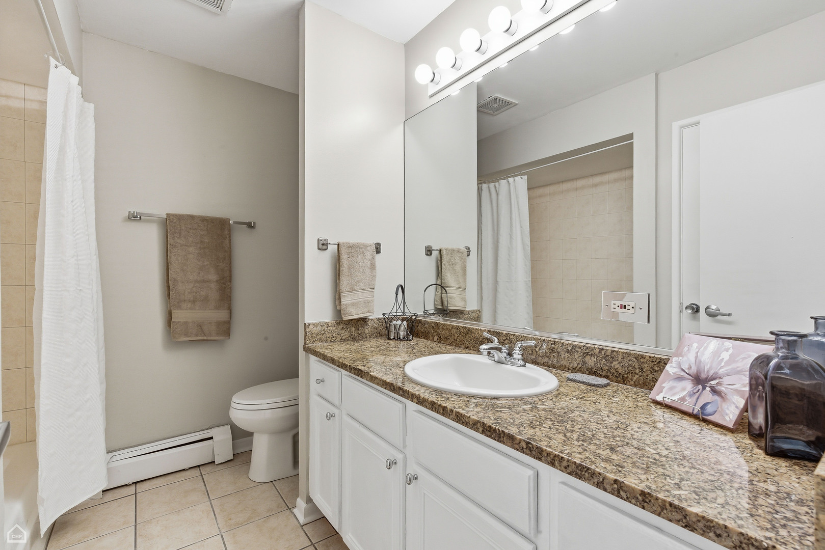 6619 North Sheridan Road, Unit 401 Chicago, IL 60626 - Photo 15 of 19 a bathroom with a granite countertop sink and a mirror