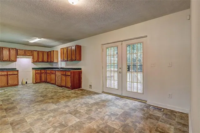 a view of a kitchen with furniture and an empty room