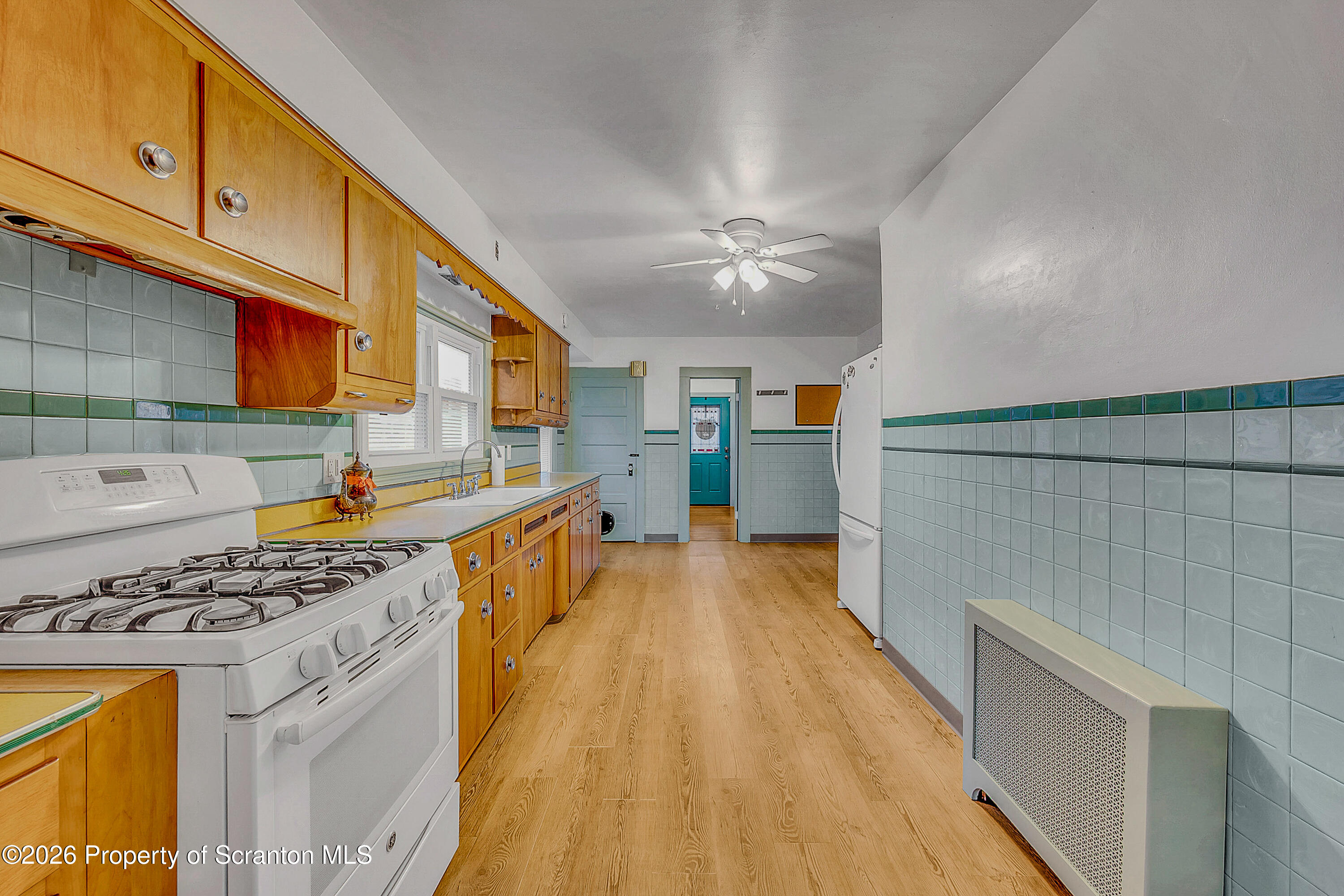 123 William Street Scranton, PA 18510 - Photo 12 of 22 a kitchen with stainless steel appliances granite countertop a stove a sink dishwasher and cabinets with wooden floor