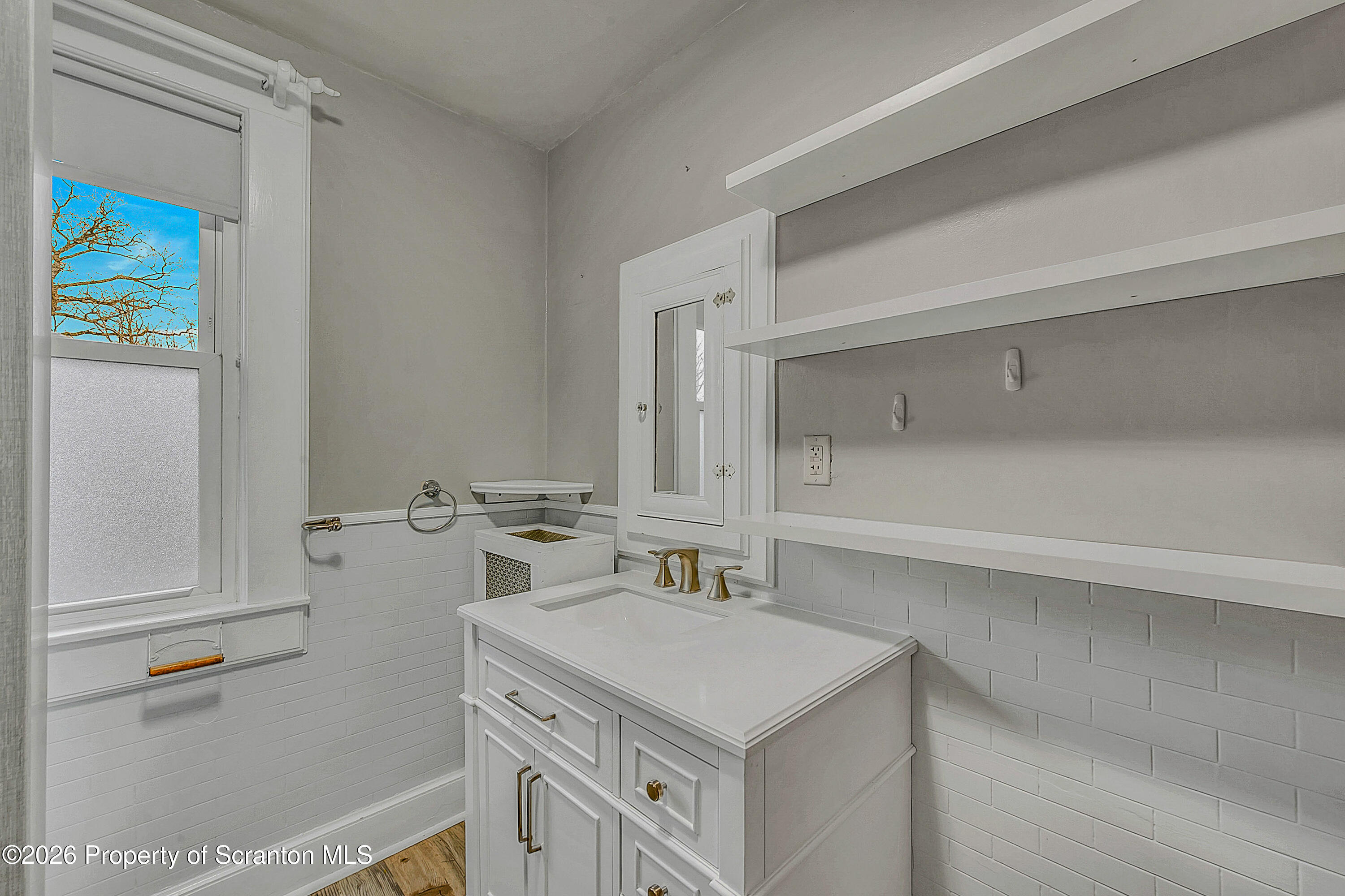 123 William Street Scranton, PA 18510 - Photo 15 of 22 a bathroom with a sink a vanity and a mirror