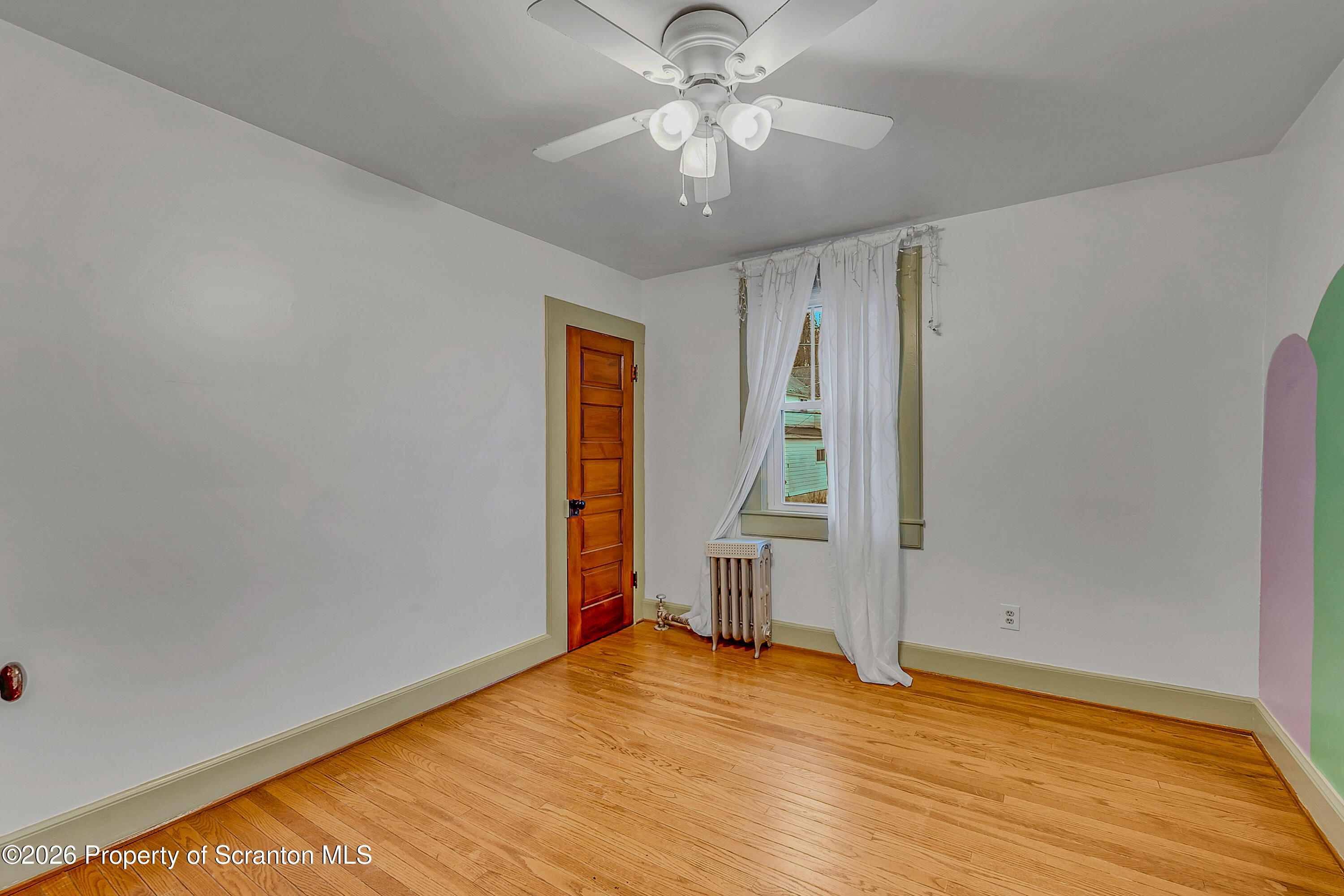 123 William Street Scranton, PA 18510 - Photo 16 of 22 a view of empty room with wooden floor and fan