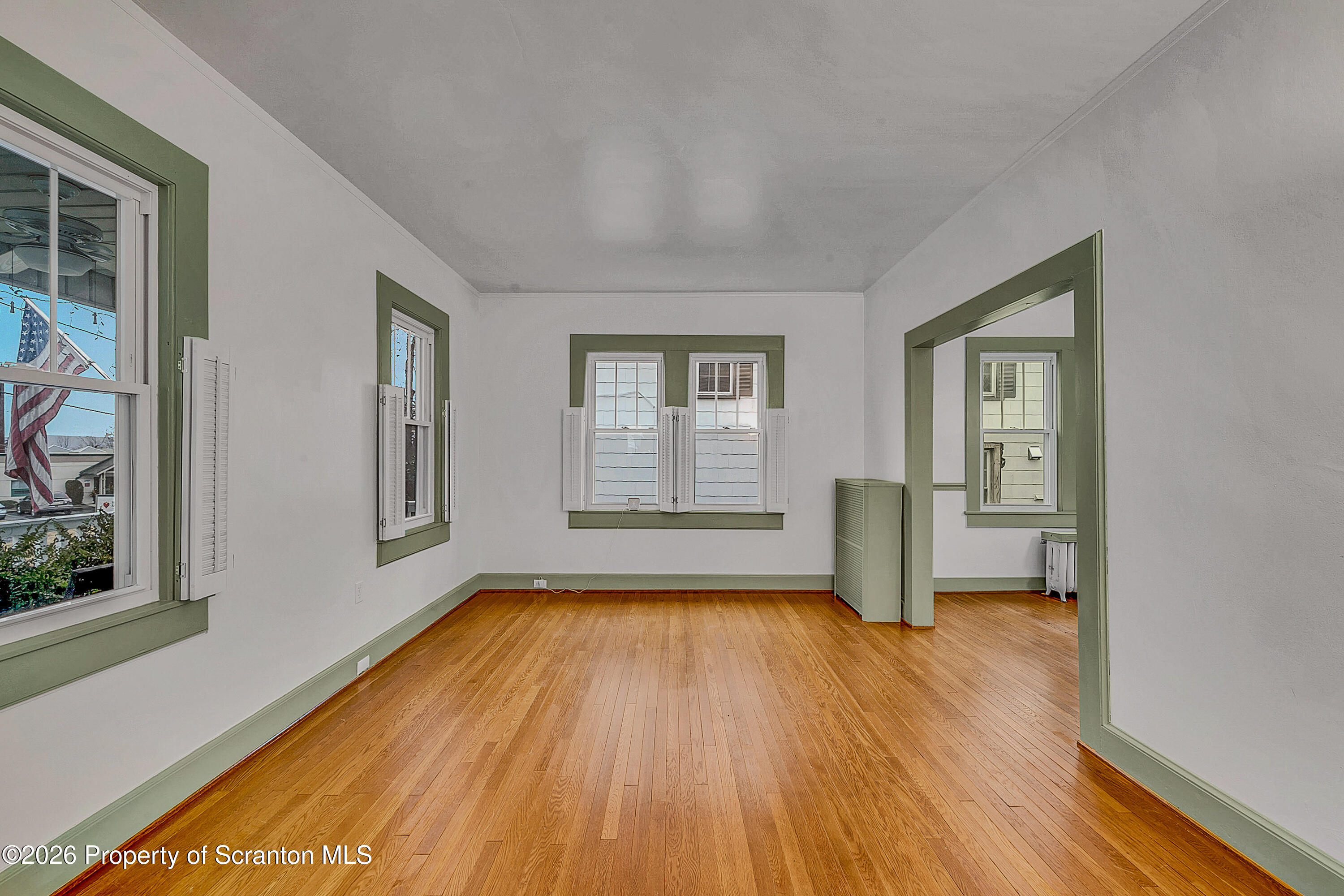 123 William Street Scranton, PA 18510 - Photo 7 of 22 a view of an empty room with wooden floor and a window
