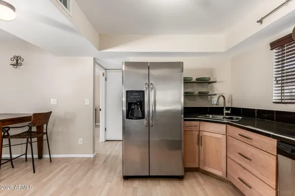 a kitchen with granite countertop a stove and a refrigerator