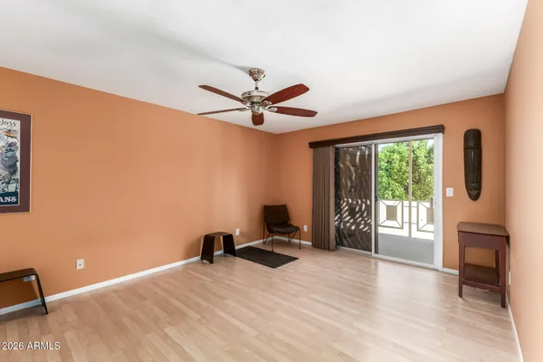 a view of room with wooden floor and ceiling fan