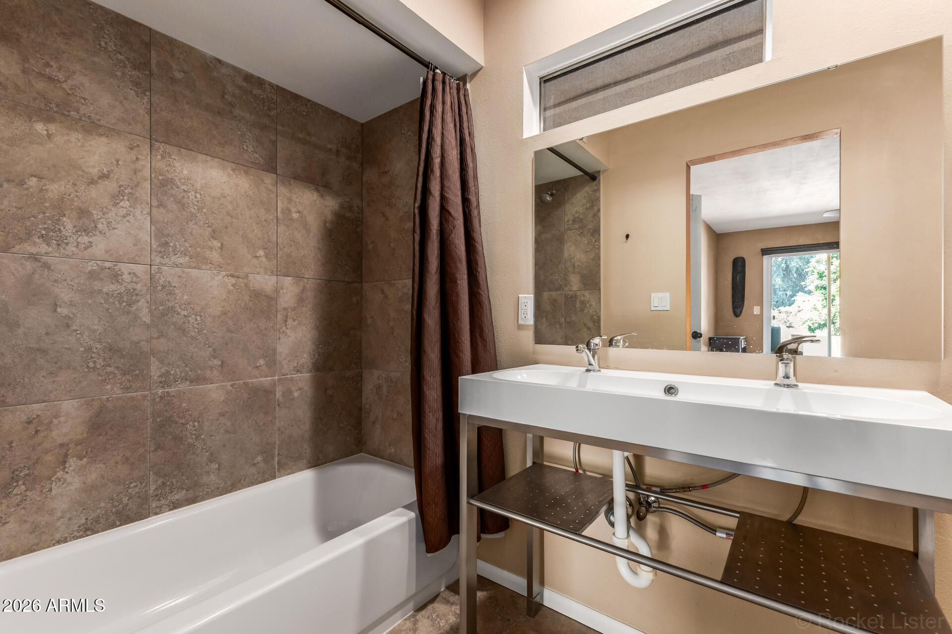 725 South Power Road, Unit 217 Mesa, AZ 85206 - Photo 15 of 29 a bathroom with a bathtub and a sink