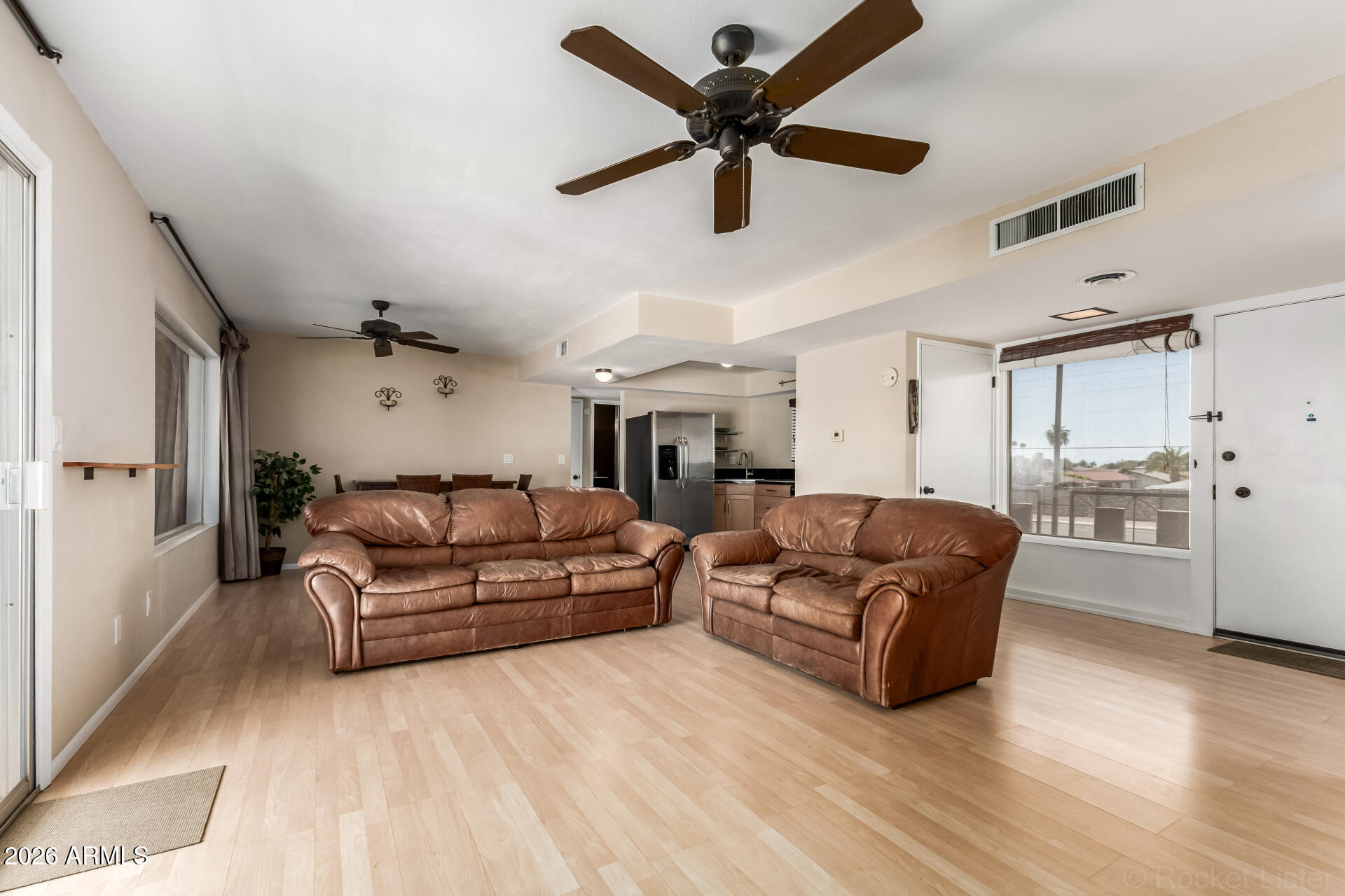 725 South Power Road, Unit 217 Mesa, AZ 85206 - Photo 4 of 29 a living room with furniture and a wooden floor