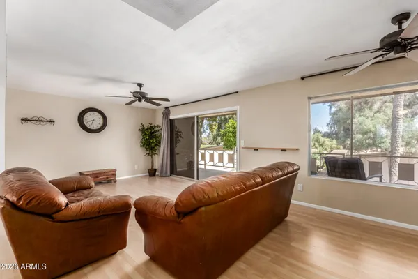a living room with furniture and a wooden floor