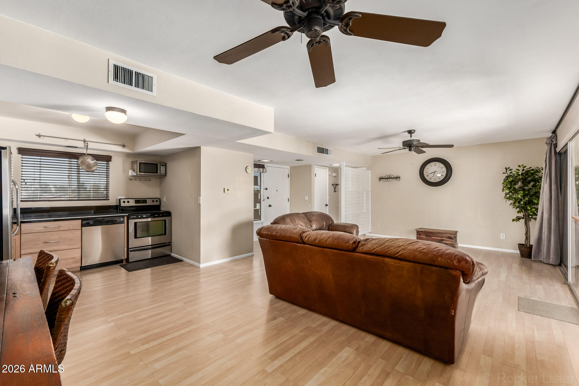 725 South Power Road, Unit 217 Mesa, AZ 85206 - Photo 7 of 29 a living room with furniture and a wooden floor