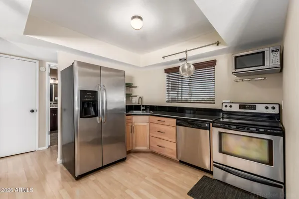 a kitchen with granite countertop a refrigerator and a stove