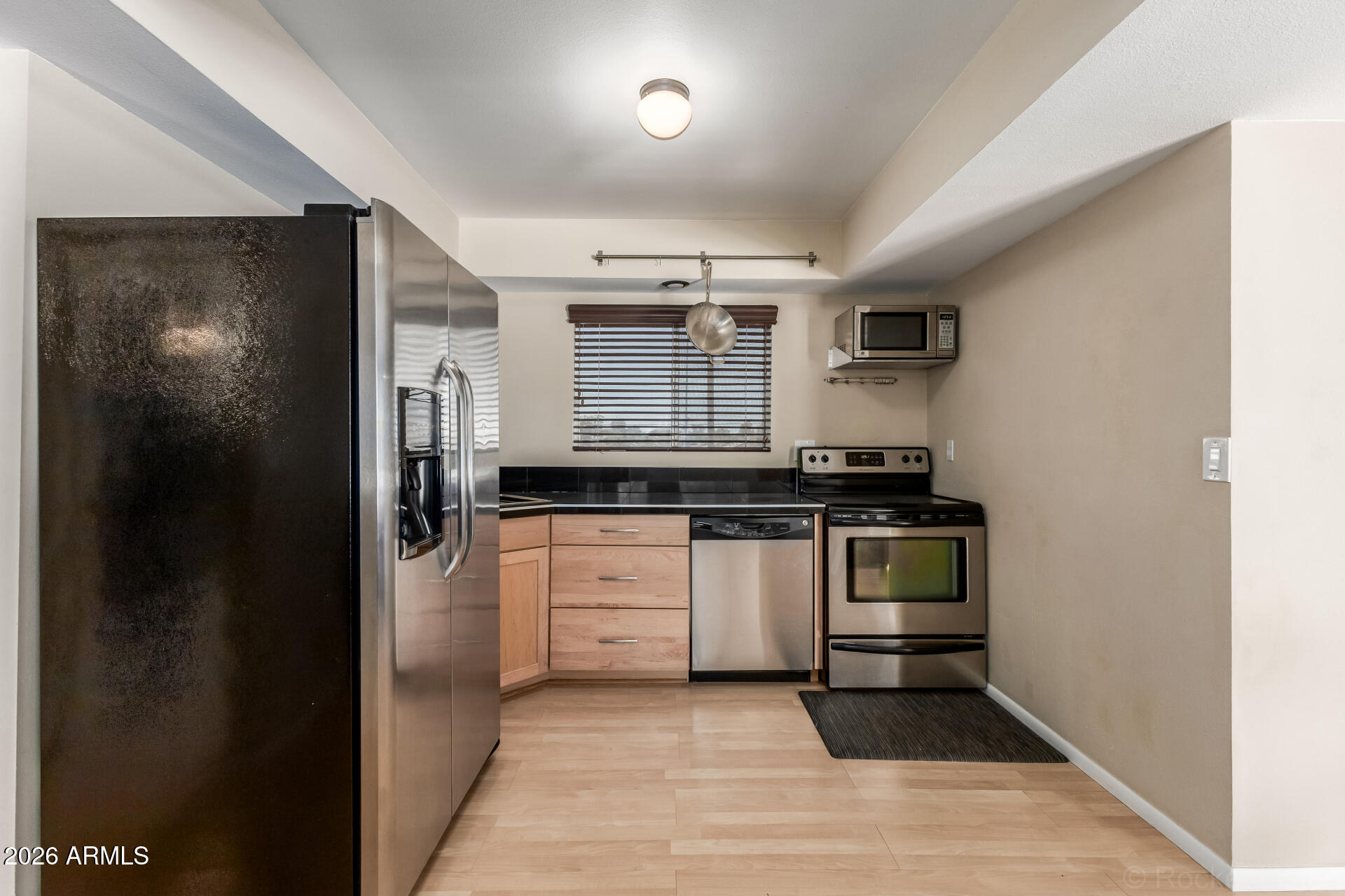 725 South Power Road, Unit 217 Mesa, AZ 85206 - Photo 10 of 29 a kitchen with granite countertop a refrigerator and a stove