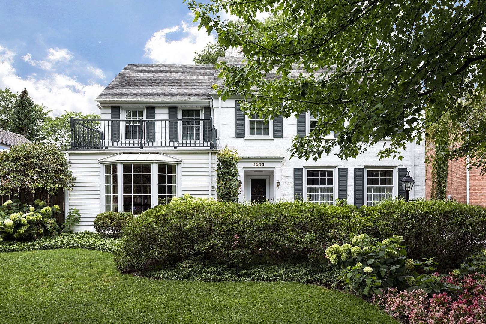 1253 Ridge Road Wilmette, IL 60091 - Photo 1 of 16 a front view of a house with a yard and trees