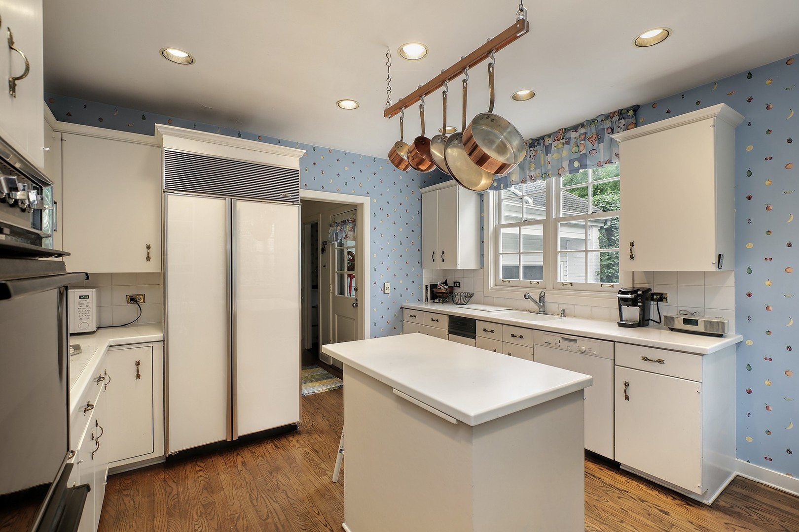1253 Ridge Road Wilmette, IL 60091 - Photo 7 of 16 a kitchen with a sink a stove a refrigerator and a window