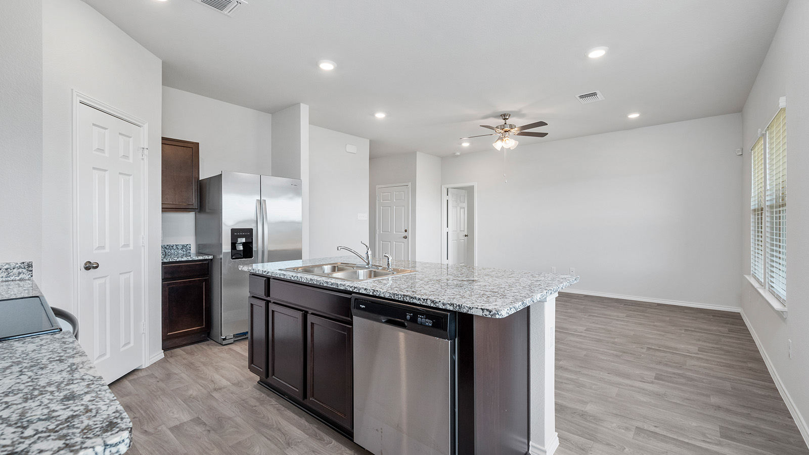 1311 Victory Rnch Trail Killeen, TX 76549 - Photo 2 of 22 Kitchen with stainless steel appliances, light wood-style floors, a kitchen island with sink, ceiling fan, and recessed lighting