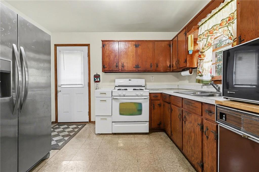 7019 Lake View Lane Doraville, GA 30360 - Photo 11 of 32 a kitchen with a refrigerator sink and cabinets