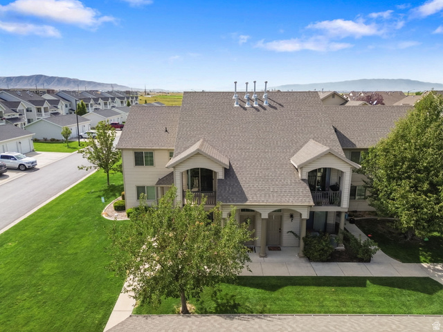 482 South 2500th West, Unit 2 Springville, UT 84663 - Photo 44 of 52 Exterior featuring light-colored siding, a covered entryway, a second-story balcony with metal railing, and a gabled roof