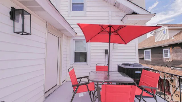 a patio with a table and chairs