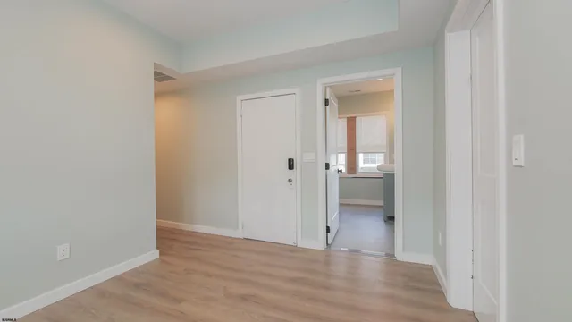 a view of an empty room with wooden floor