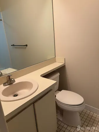 a bathroom with a sink a toilet and mirror