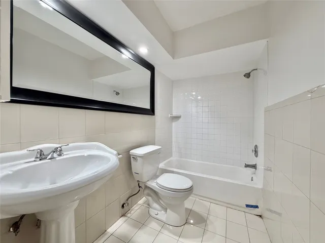 a bathroom with a sink a toilet and a bathtub