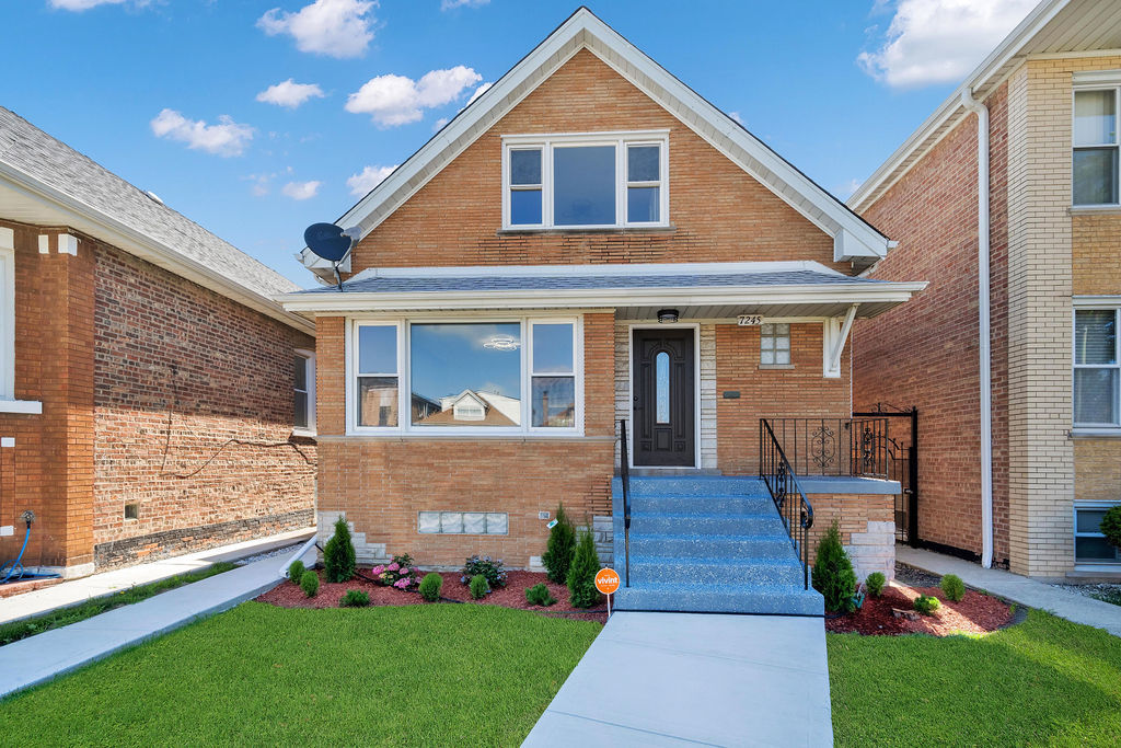 a front view of house with yard and green space