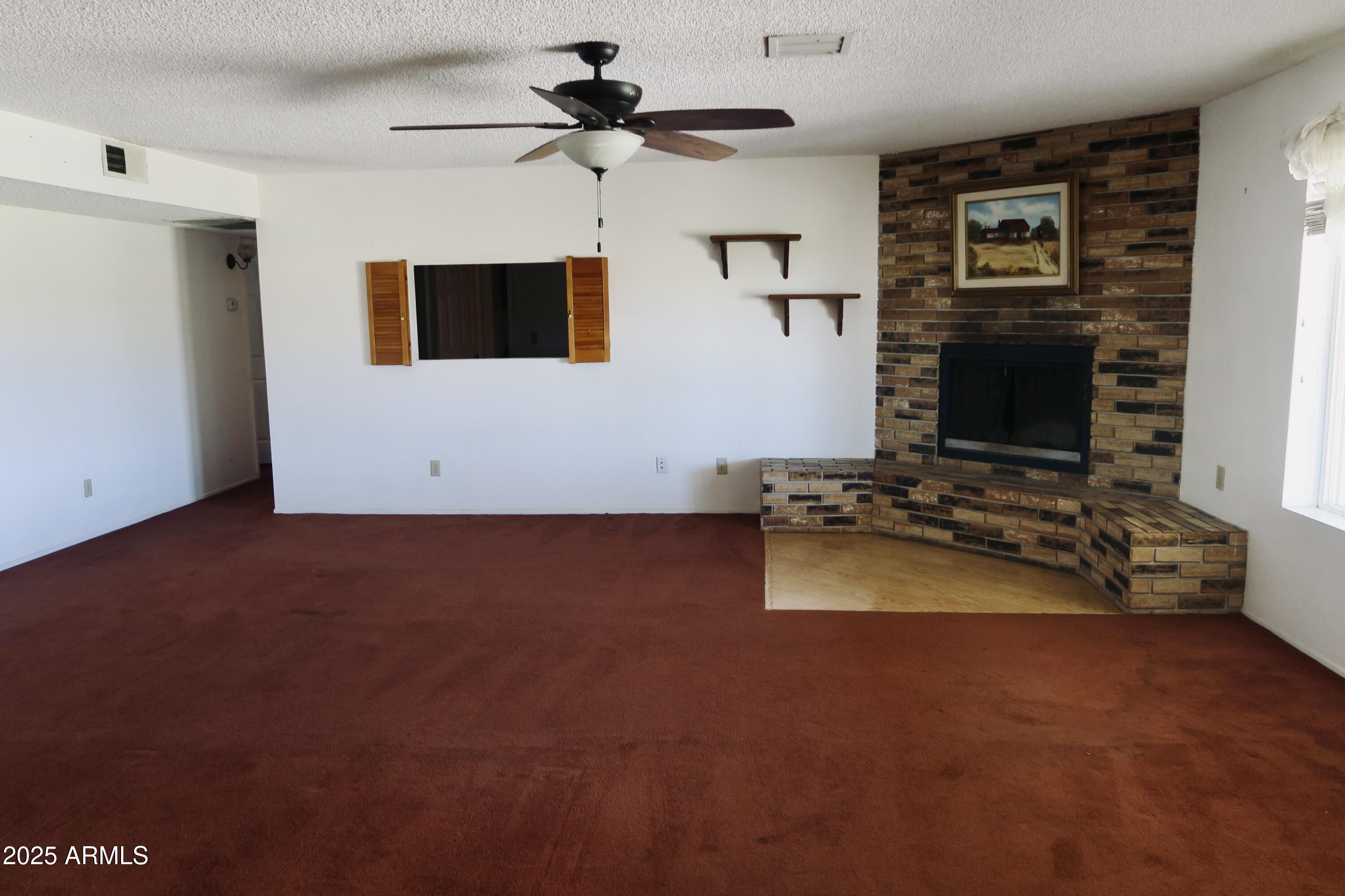 9208 South Palo Verde Road Buckeye, AZ 85326 - Photo 18 of 27 a living room with furniture and a flat screen tv