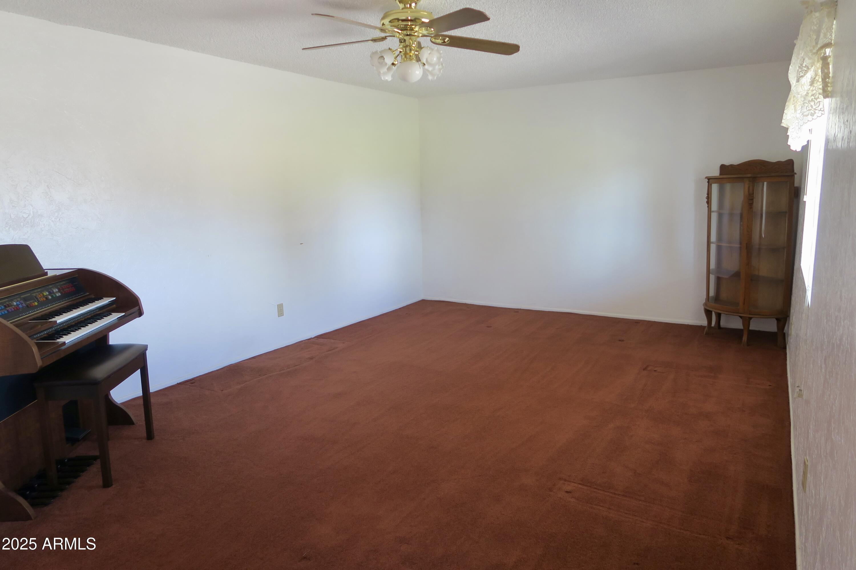 9208 South Palo Verde Road Buckeye, AZ 85326 - Photo 19 of 27 a view of room with window and ceiling fan