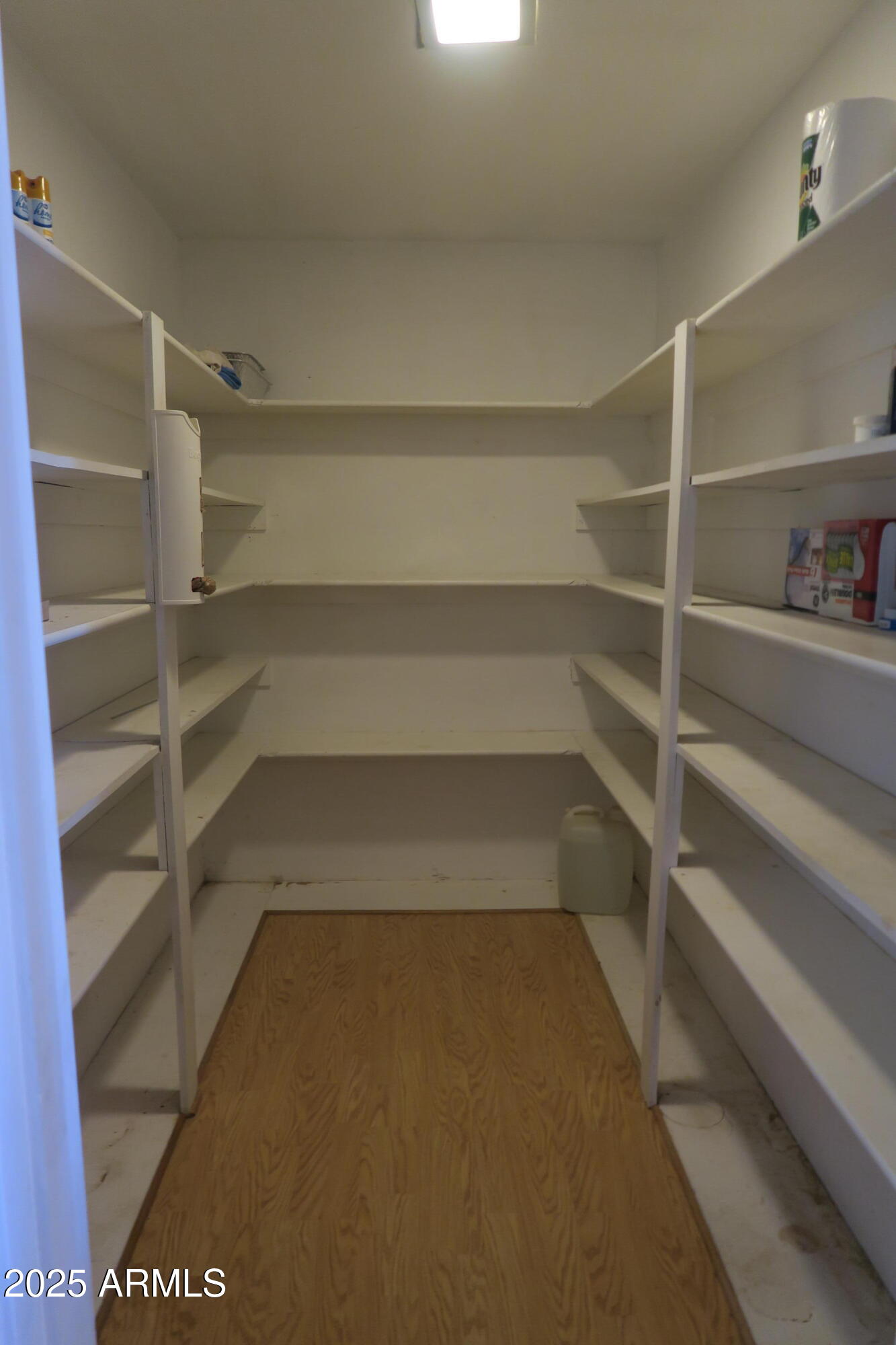 9208 South Palo Verde Road Buckeye, AZ 85326 - Photo 25 of 27 a view of walk in closet with empty racks