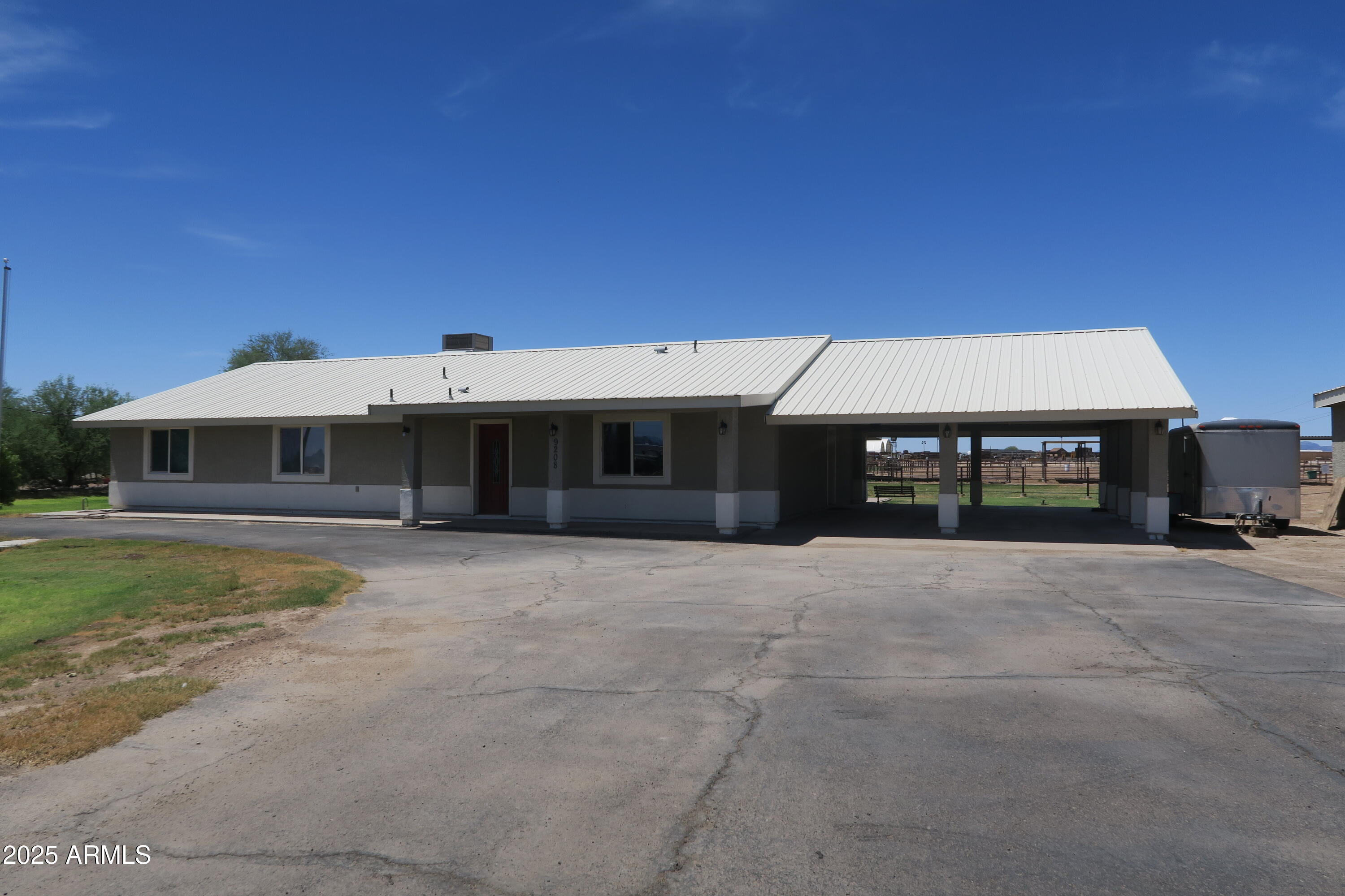 9208 South Palo Verde Road Buckeye, AZ 85326 - Photo 26 of 27 a front view of a house with a yard