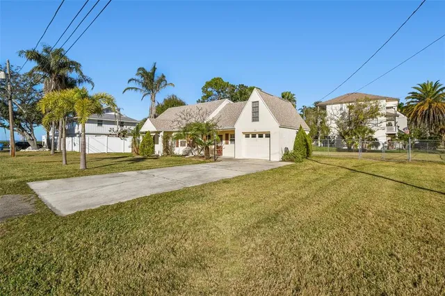 a view of an house with backyard and tree