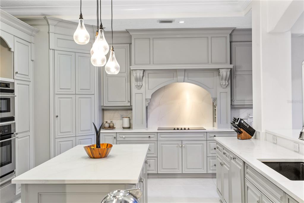 222 Acadia Terrace Celebration, FL 34747 - Photo 16 of 76 a kitchen with a sink a stove and cabinets with wooden floor