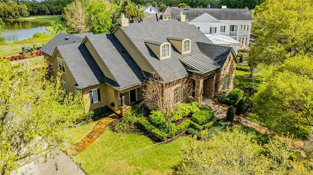 an aerial view of a house with a yard basket ball court and outdoor seating