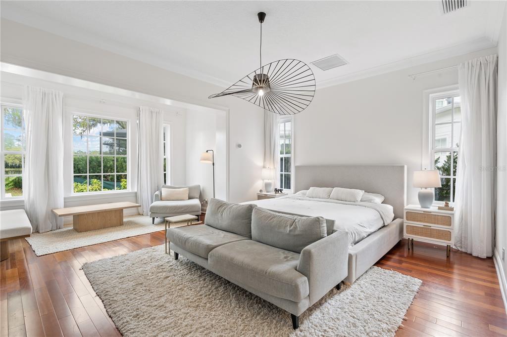 222 Acadia Terrace Celebration, FL 34747 - Photo 21 of 76 a spacious bedroom with a bed a couch and a window